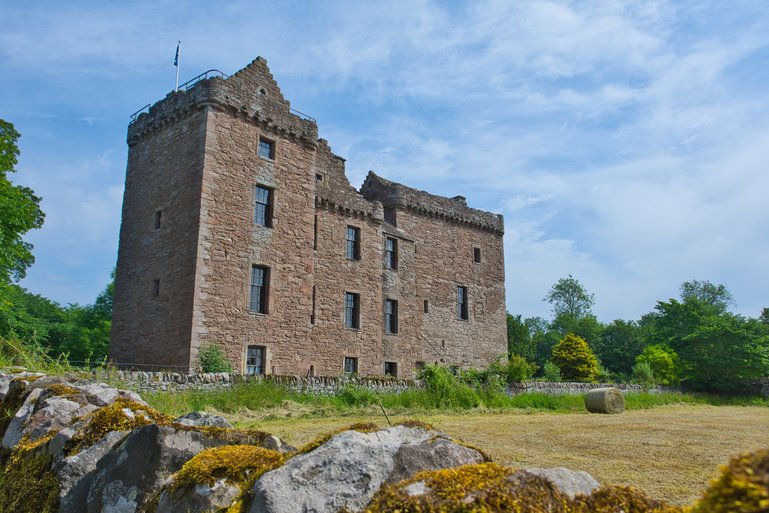 Huntingtower Palace stands tall surrounded by farmland
